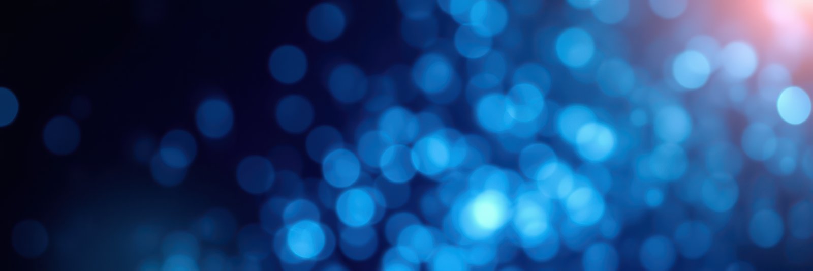 Colorful bokeh lights create a vibrant background effect during a night event with a festive atmosphere